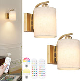 Gold wall sconces with white lampshades, remote controls, and smart light bulb on a white background.